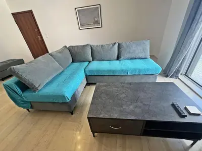 a living room with a blue couch and a coffee table at Apartment near megaro mousikis metro station in Athens