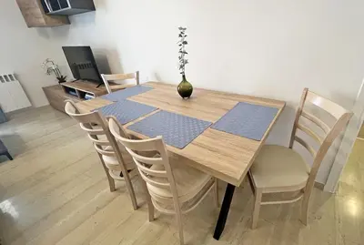 a dining room table with chairs and a vase on it at Apartment near megaro mousikis metro station in Athens