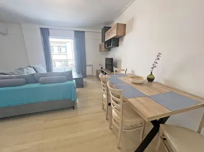 a living room with a table and a couch at Apartment near megaro mousikis metro station in Athens