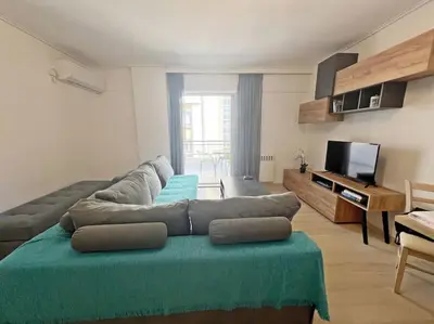 a living room with a couch and a flat screen tv at Apartment near megaro mousikis metro station in Athens