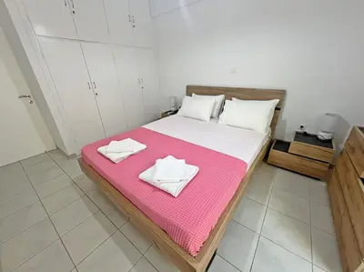 a bedroom with a bed with two towels on it at Apartment near megaro mousikis metro station in Athens