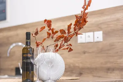 a bottle of wine and two glasses with a plant at Loft15Athens in Athens