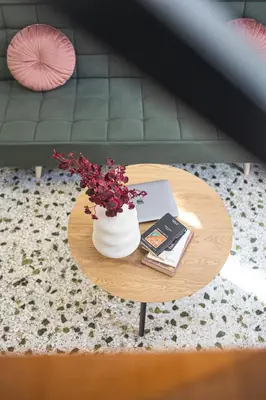 a table with a vase of flowers and a book at Loft15Athens in Athens