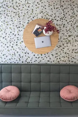 a table with a laptop and flowers on it at Loft15Athens in Athens