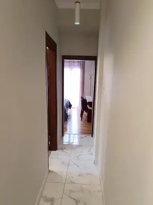 an empty room with a hallway with a person bending over at Koukaki Hideaway Suite in Athens