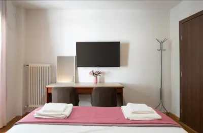 a bedroom with a desk with two chairs and a bed at Koukaki Hideaway Suite in Athens