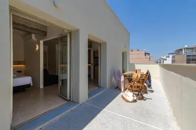 a balcony with a table and chairs on a building at Mooeve Psyri in Athens