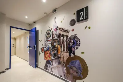 a hallway with a mural on the wall at Mooeve Psyri in Athens