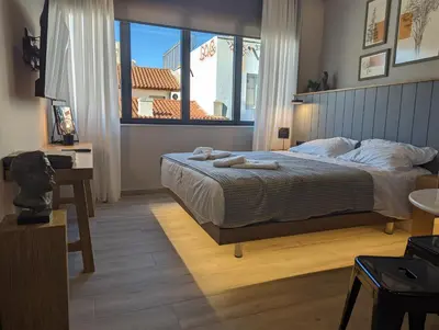 a bedroom with a bed and a large window at Triple A - Psiri Fruit Market Artistic Studios - FREE Parking in Athens