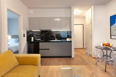 a kitchen and living room with a couch and a table at Synathens Syntagma Apartments in Athens