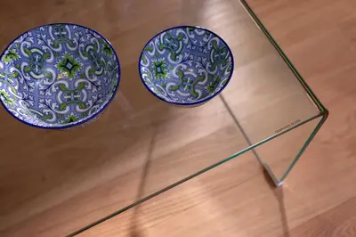 two plates sitting on top of a glass table at Synathens Syntagma Apartments in Athens