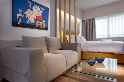 a living room with a couch and a bed at Synathens Syntagma Apartments in Athens