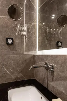 a bathroom with a bath tub and a mirror at Synathens Syntagma Apartments in Athens