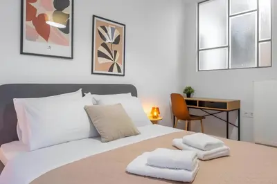 a bedroom with a bed with two towels on it at Nobe Acropolis Suite in Athens