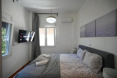 a bedroom with a bed and a window at The Cozy Studio, Nea Smyrni in Athens