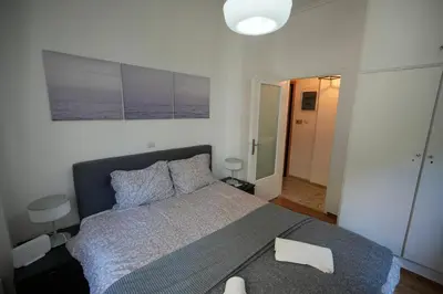 a bedroom with a large bed with a gray blanket at The Cozy Studio, Nea Smyrni in Athens