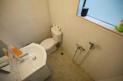 a small bathroom with a toilet and a sink at The Cozy Studio, Nea Smyrni in Athens