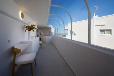a room with chairs and tables on a balcony at BlueNote Suites in Athens