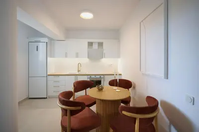 a kitchen with a table and chairs and a counter at BlueNote Suites in Athens