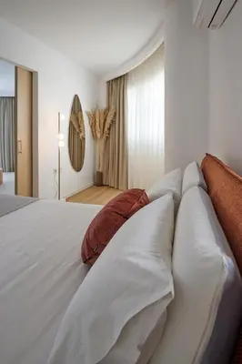 a bedroom with a large white bed with pillows at BlueNote Suites in Athens