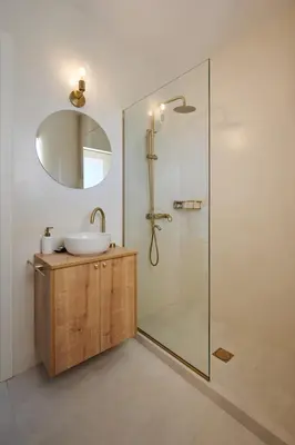 a bathroom with a sink and a shower with a mirror at BlueNote Suites in Athens
