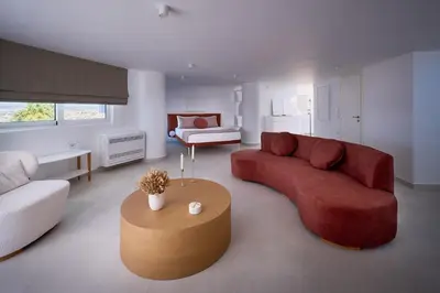 a living room with a red couch and a coffee table at BlueNote Suites in Athens
