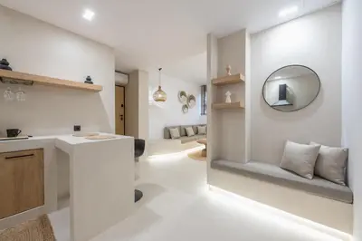 a white bathroom with a sink and a mirror at Exarcheia Luxury Apartment in Athens