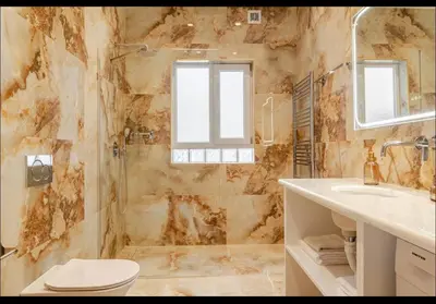 a bathroom with a shower and a toilet and a sink at Aether Residences in Athens