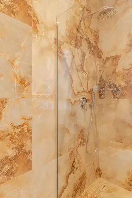 a bathroom with a shower with a glass door at Aether Residences in Athens