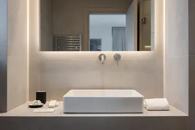 a bathroom with a white sink and a mirror at Athenian Riviera Coastal Charm Villa in Athens