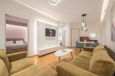 a living room with a couch and a table at Dream Athens Stay Cozy 3BR with balcony in Athens