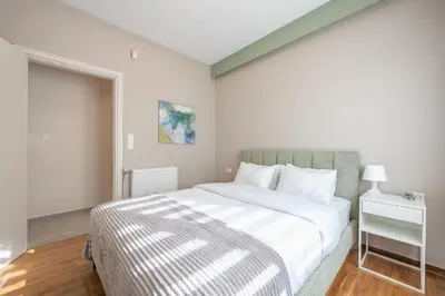 a white bedroom with a large bed and a window at Dream Athens Stay Cozy 3BR with balcony in Athens