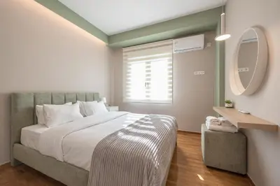 a bedroom with a large bed and a mirror at Dream Athens Stay Cozy 3BR with balcony in Athens