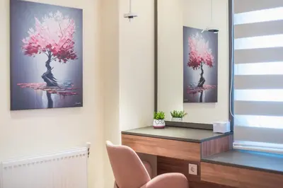 a living room with a pink tree painting on the wall at Dream Athens Stay Cozy 3BR with balcony in Athens