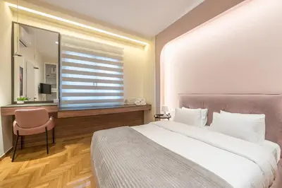 a bedroom with a bed and a desk and a window at Dream Athens Stay Cozy 3BR with balcony in Athens