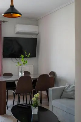 a living room with a table and a couch at 3BA next to metro and Athens city center with view in Athens