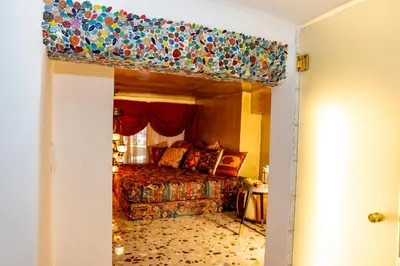 a bedroom with a bed with a colorful bedspread at 1001 Nights - Low Celling Studio in downtown in Athens