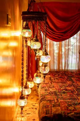 a row of lights on a table in a room at 1001 Nights - Low Celling Studio in downtown in Athens