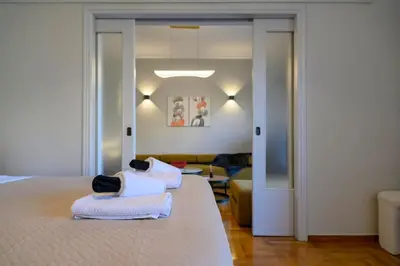 a bedroom with a bed with two towels on it at Stunning Acropolis 2 bedroom Opulence in Athens