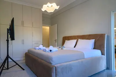 a bedroom with a large bed with two towels on it at Stunning Acropolis 2 bedroom Opulence in Athens