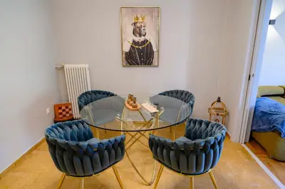 a dining room with a glass table and chairs at Stunning Acropolis 2 bedroom Opulence in Athens