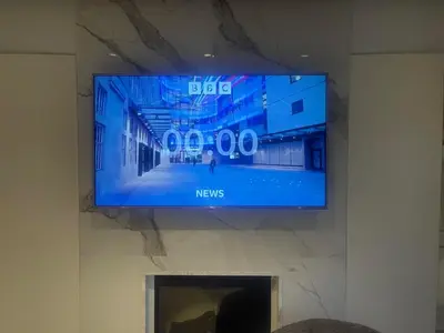 a flat screen tv hanging on a wall at Athens Riviera Lux Flat, Lemos Vouliagmeni in Athens