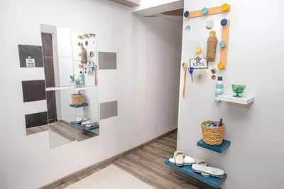 a room with shoes on display on a wall at Summer flat by the beach&Taverna in Piraeus