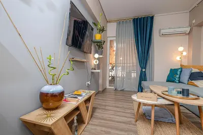 a living room with a couch and a table at Summer flat by the beach&Taverna in Piraeus