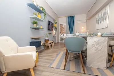 a kitchen and living room with a table and chairs at Summer flat by the beach&Taverna in Piraeus