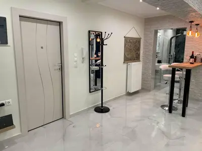 a room with a door and a table with a mirror at Oasis of Ralaxation in Athens in Athens