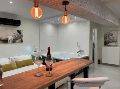 two glasses of wine on a wooden bar in a kitchen at Oasis of Ralaxation in Athens in Athens