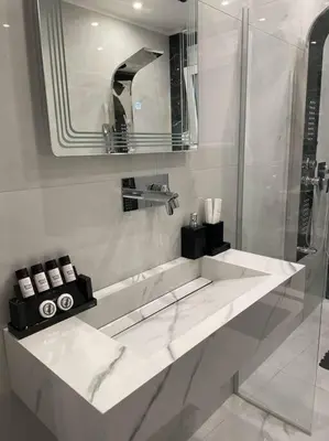 a white bathroom with a sink and a shower at Oasis of Ralaxation in Athens in Athens