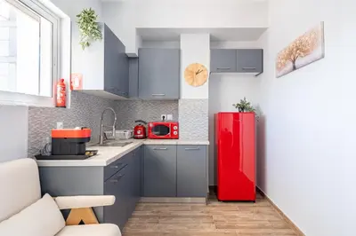 a kitchen with a red refrigerator in a room at Glyfada center seaview B in Athens
