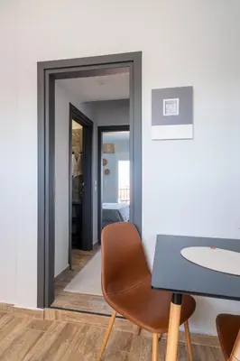 a dining room with a table and a mirror at Glyfada center seaview B in Athens
